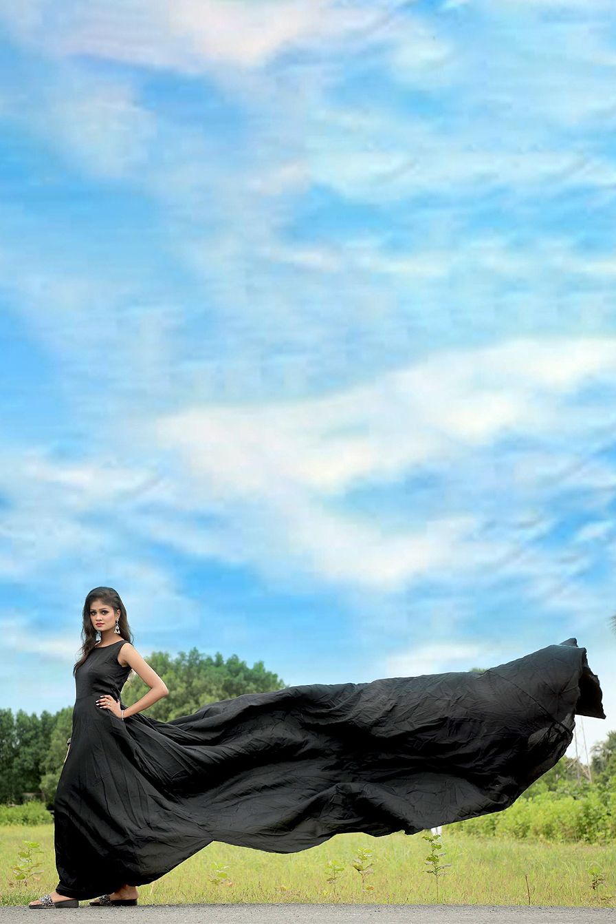 Black Satin Sleeveless Gown With Minimal Yoke And Flarey Back Tail